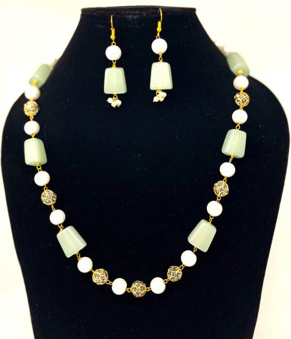 TB pearl strings set with Sea Green natural stone and studded gold bids
