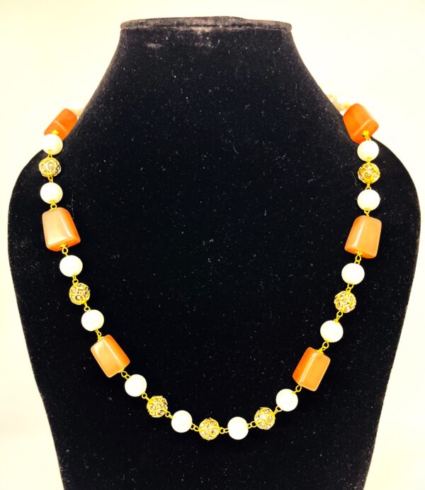 TB pearl strings set with Tan natural stone and studded gold bids
